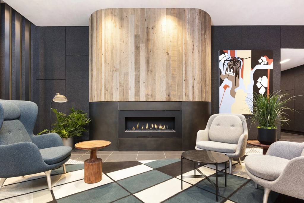 A modern living room with a fireplace and comfortable seating.