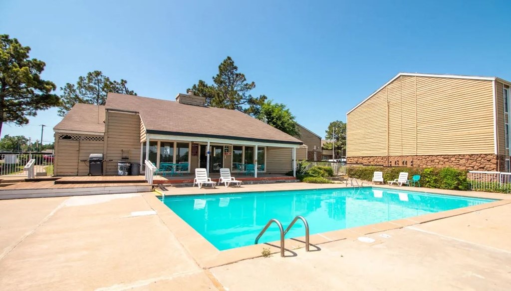 a swimming pool with a house in the background