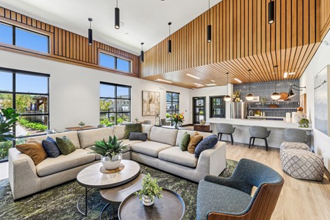 A modern living room with a wooden ceiling and white walls at The Arboretum Apartments, Farmingville
