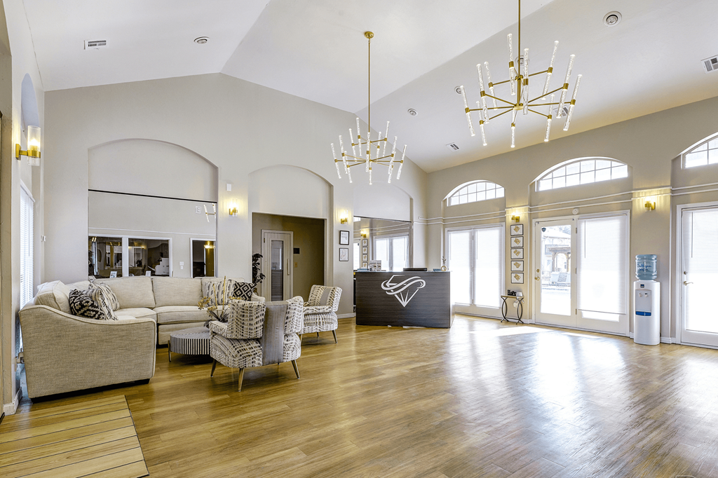 a large living room with couches and chairs and a reception desk at Diamond  Trail Apartments, Oklahoma