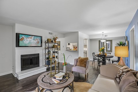 A living room with a fireplace and a painting on the wall.