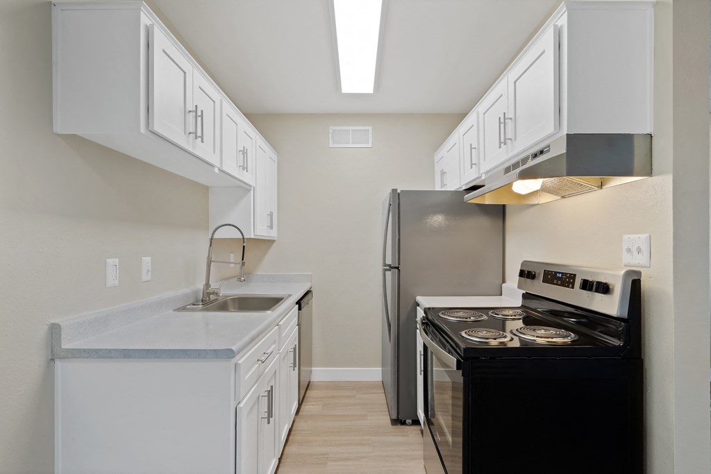 Kitchen with white cabinets and a black stove and refrigerator Kitchen with white cabinets and a black stove and refrigerator