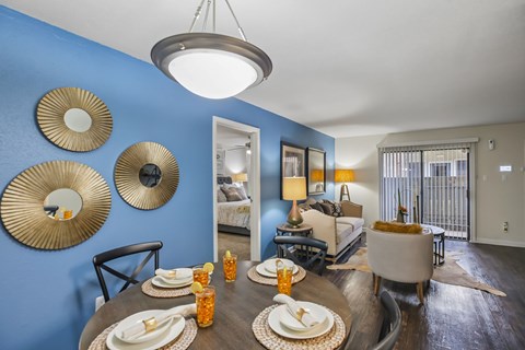 A dining room with a table set for a meal.
