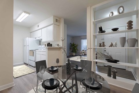 A modern kitchen with a glass dining table and chairs.