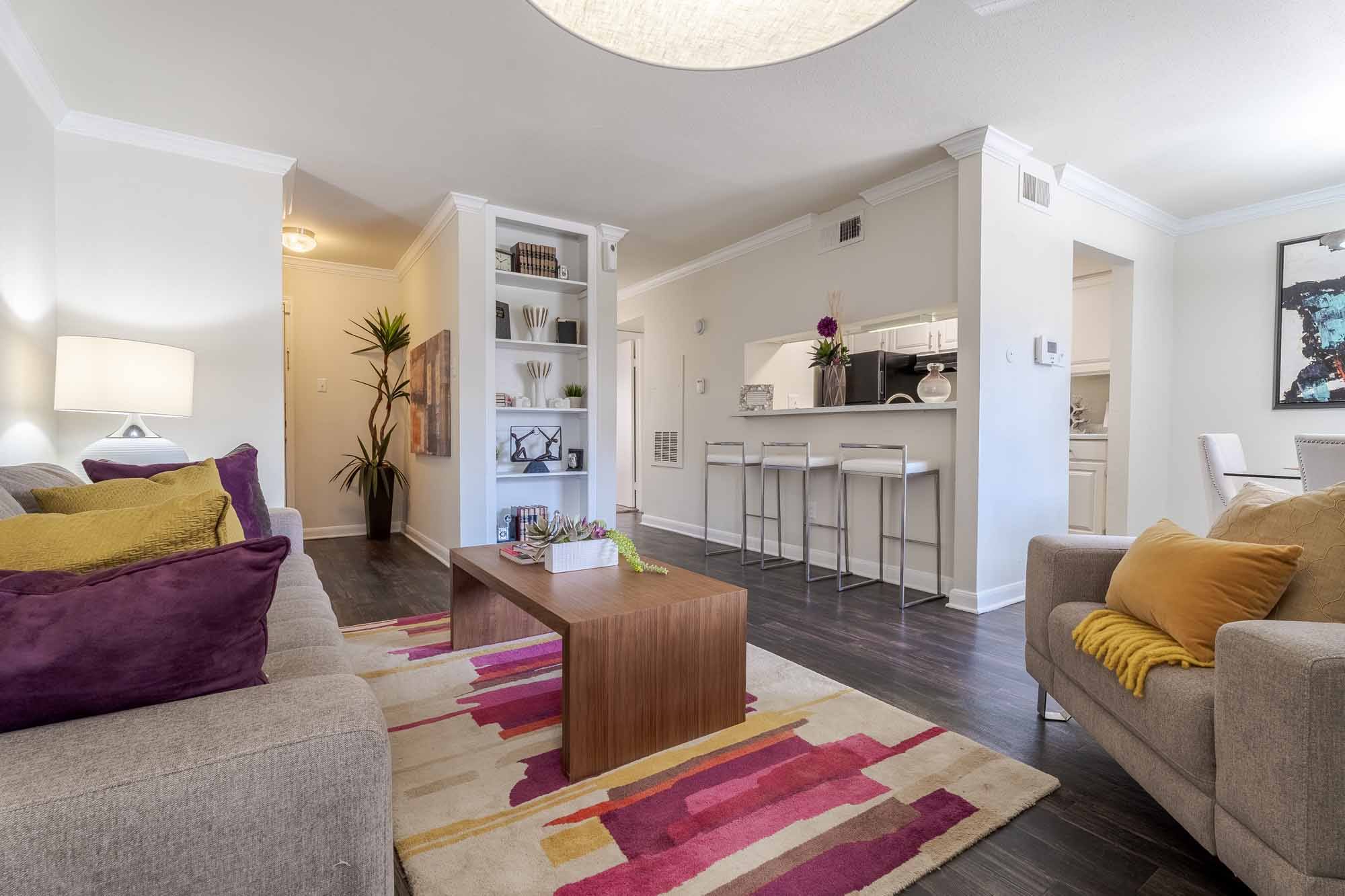 A living room with a grey couch and a wooden coffee table.