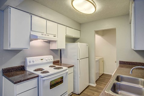 a kitchen with white appliances and white cabinets