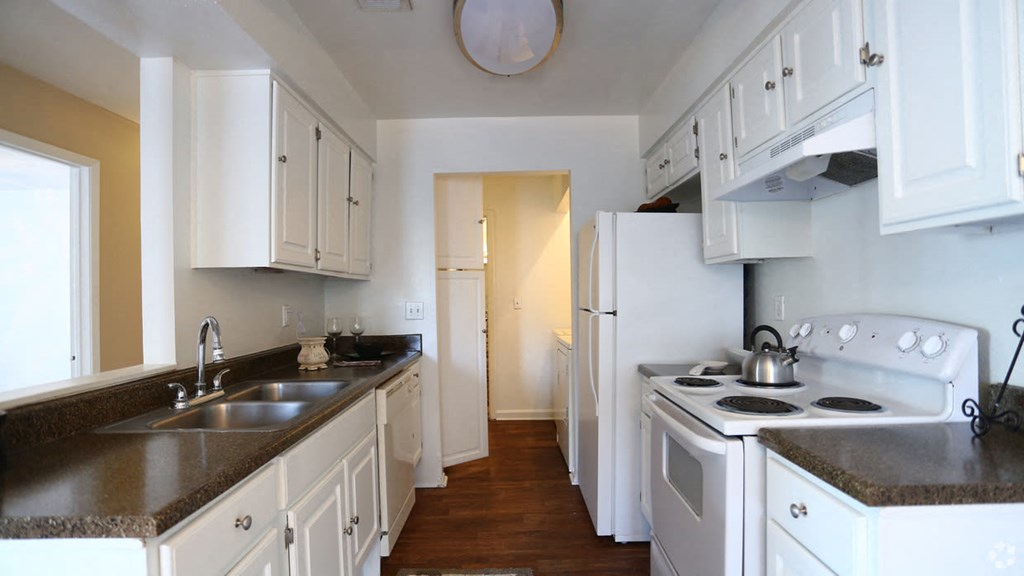 a kitchen with white appliances and white cabinets