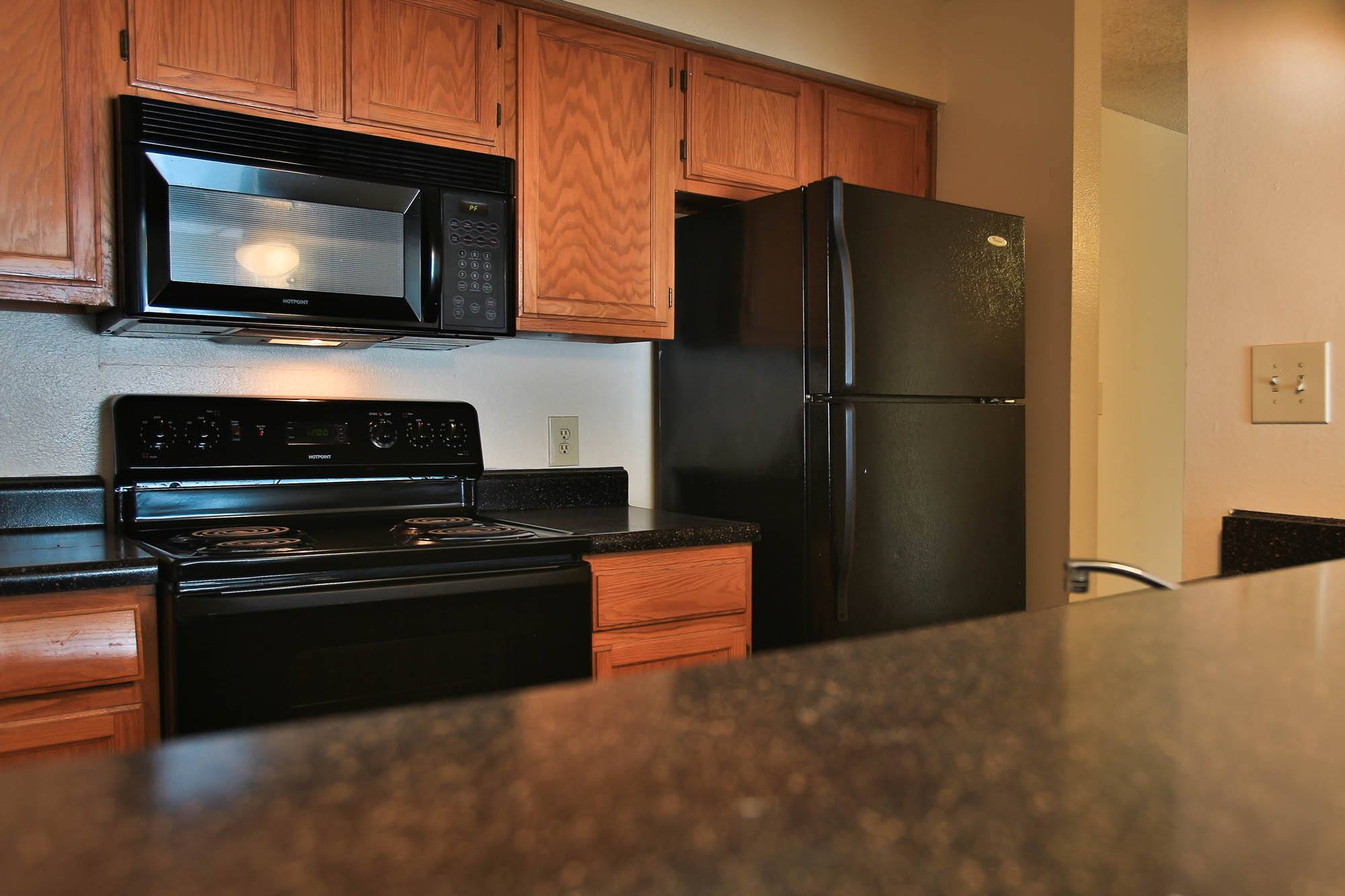 a kitchen with black appliances and a counter top