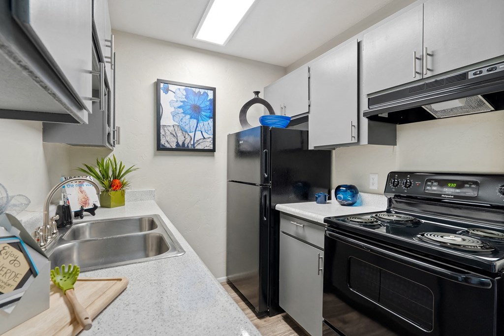 Kitchen with stainless steel appliances and a stove and refrigerator at Verde Apartments in Tucson, 85719