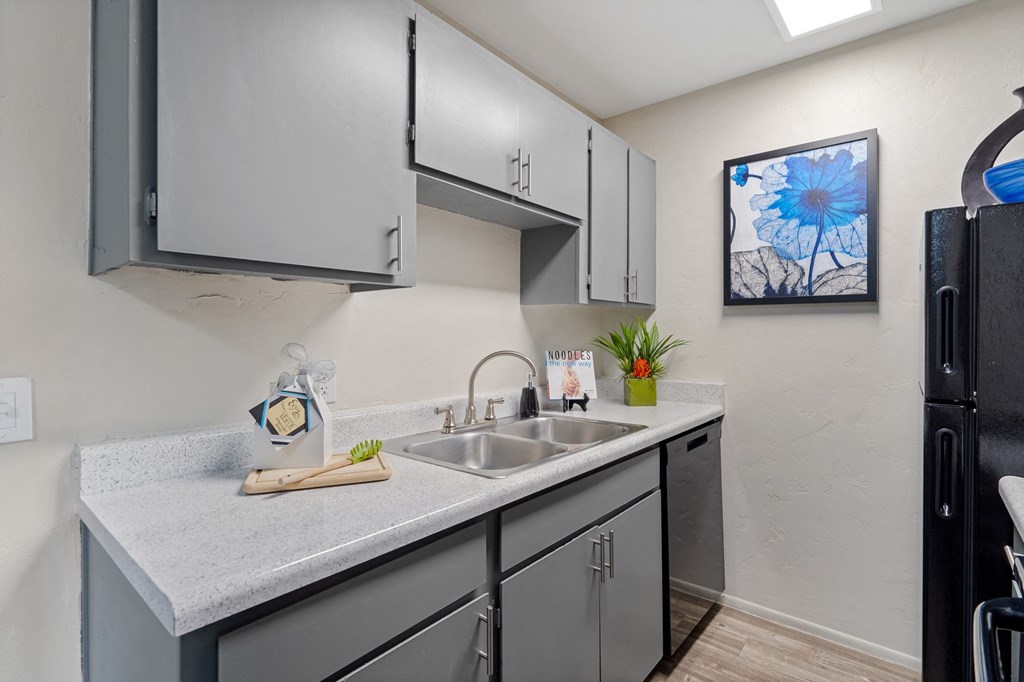 Redesigned kitchen is equipped with stainless steel appliances and a quartz counter top at Verde Apartments in Tucson, AZ, 85719