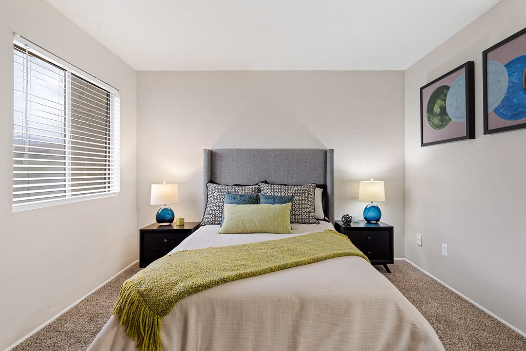 Bedroom with Bed and end tables with lamps at Verde Apartments in Tucson, AZ!