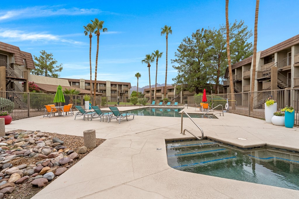 Resort Style Pool and Sundeck with Palm Trees at Verde Apartments in Tucson, AZ.