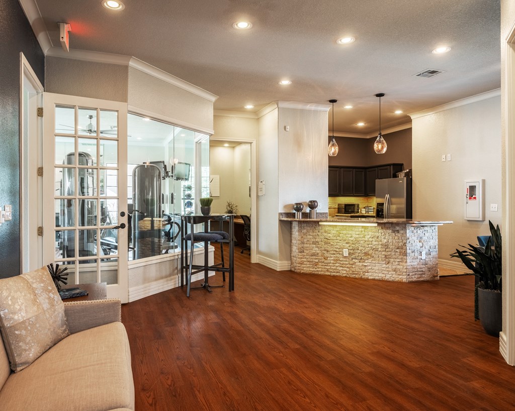 Kitchen and living room with hardwood floors at Park Hudson Place Apartments, Bryan, TX, 77802