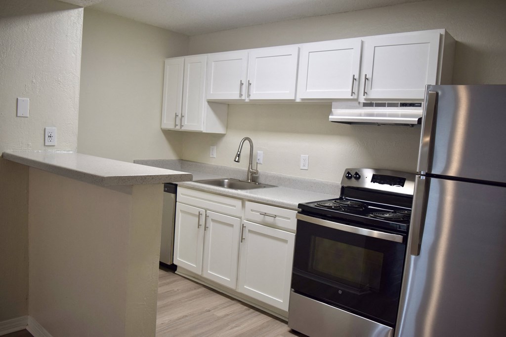 a kitchen with stainless steel appliances and white cabinets a kitchen with stainless steel appliances and white cabinets