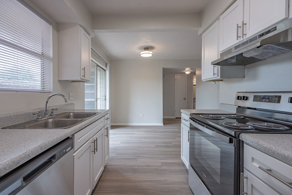Kitchen with white cabinets and a stainless steel stove  at Riverstone, Bryan
