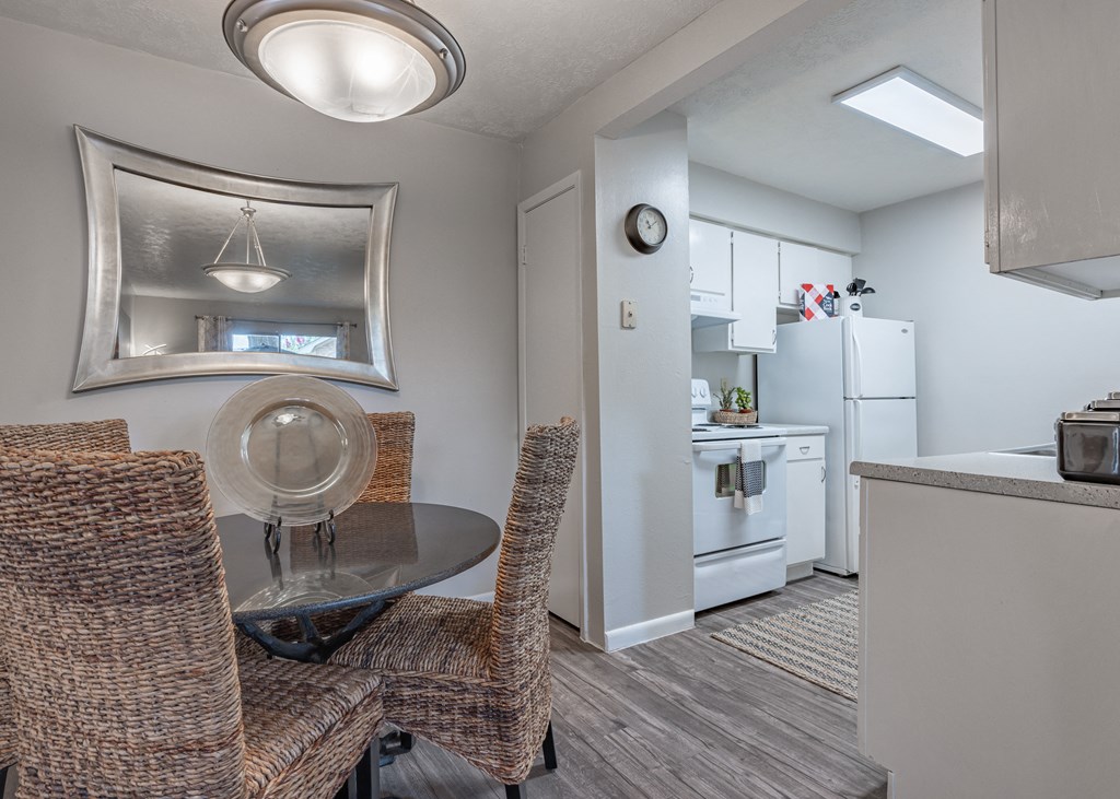 Dining area with a table and chairs and a kitchen in the background  at Riverstone, Bryan, TX