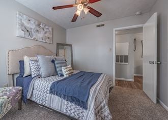 Bedroom with a bed and a ceiling fan  at Riverstone, Bryan, TX, 77802