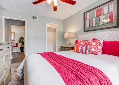 Bedroom with a bed and a ceiling fan at Sausalito Apartments, College Station, TX