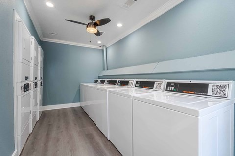 A row of washing machines in a laundry room.