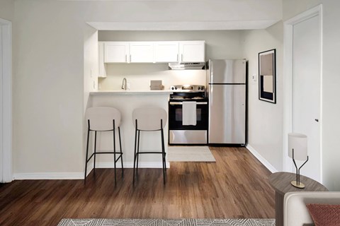 A kitchen with a refrigerator, oven, and sink is visible.
