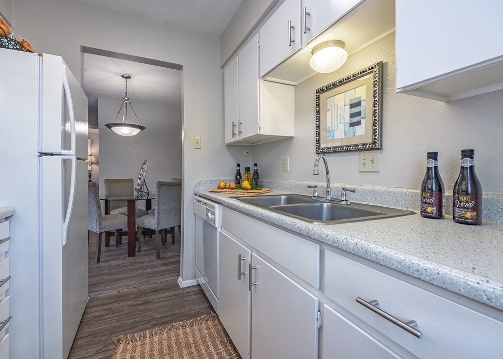 Kitchen with white cabinets and a stainless steel sink  at Willow Oaks, Texas, 77802