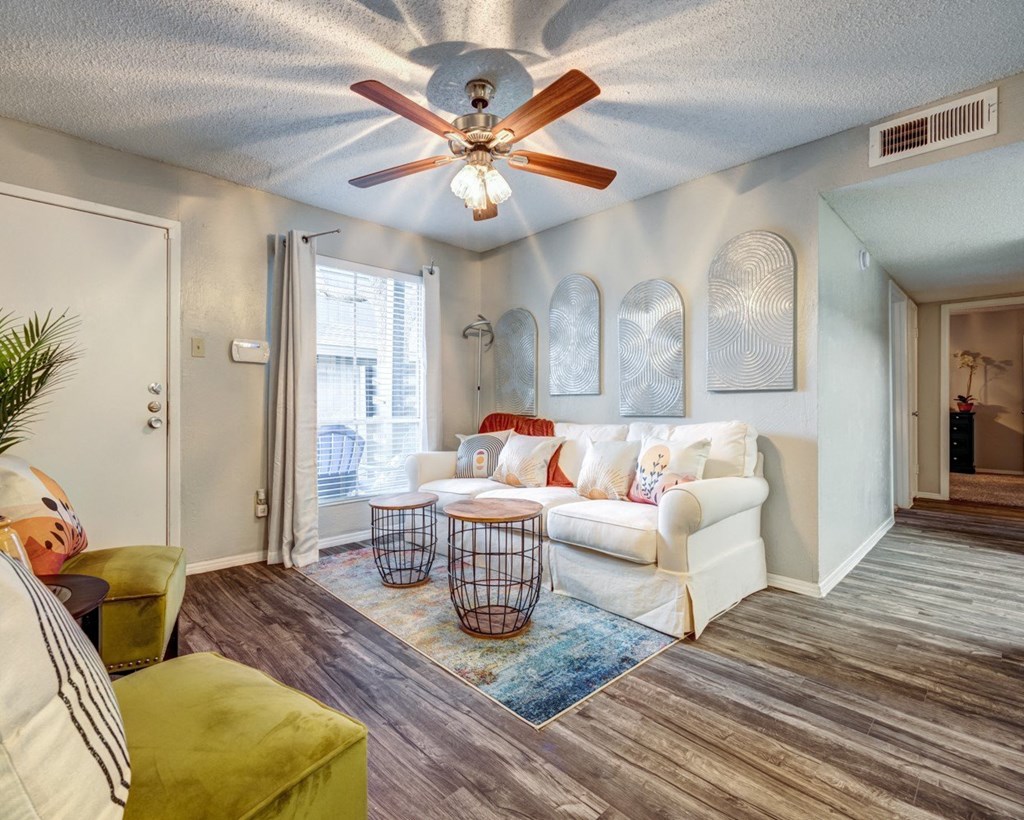 Living room with a white couch and a ceiling fan  at The Wick, Texas, 77840