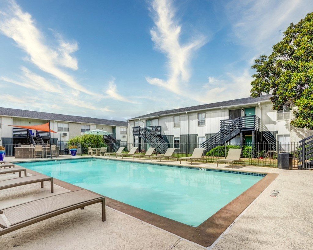 Swimming pool with relaxing sunbeds at The Wick, Texas