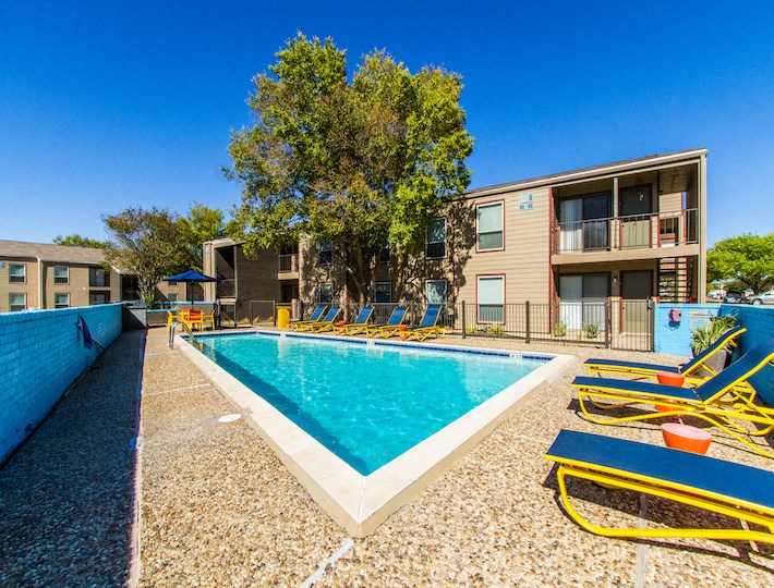 our apartments have a large pool and lounge chairs at Sundance and Sausalito Apartments, Texas