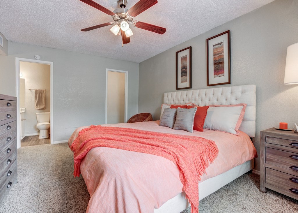 the master bedroom has a large bed and a ceiling fan at Sundance and Sausalito Apartments, Texas