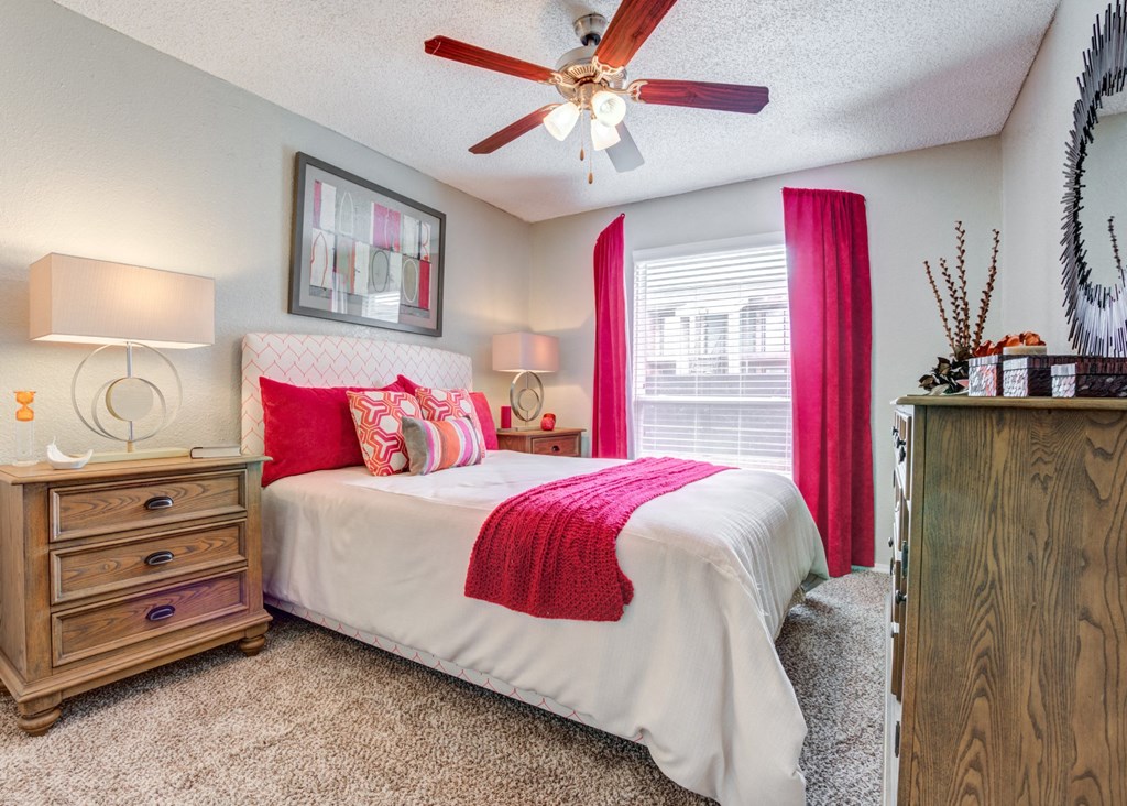 a bedroom with a bed and a ceiling fan at Sundance and Sausalito Apartments, College Station