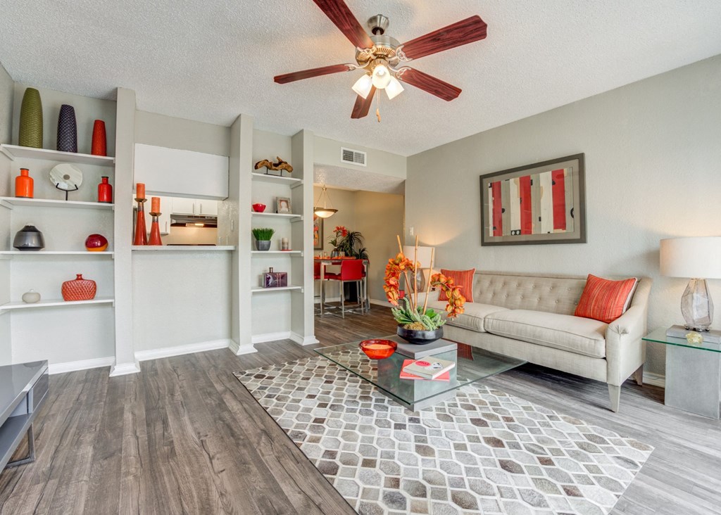 a living room with a ceiling fan and a couch at Sundance and Sausalito Apartments, College Station, Texas