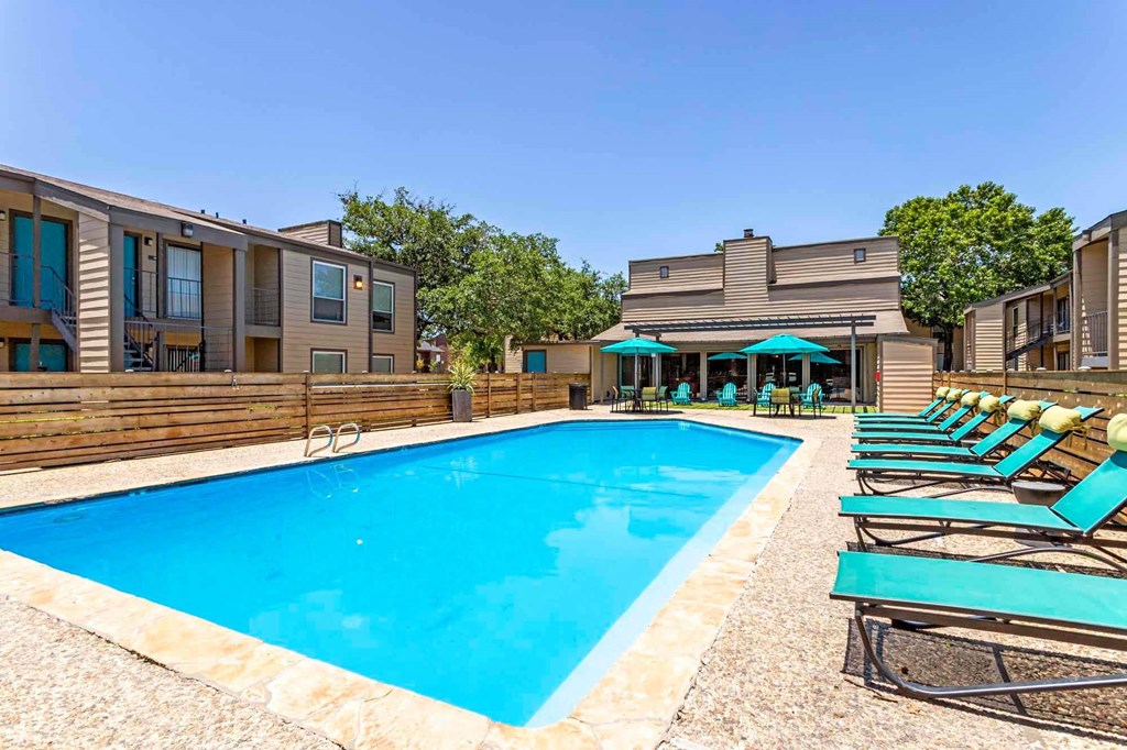 a pool and lounge chairs at Sundance and Sausalito Apartments, College Station, 77840