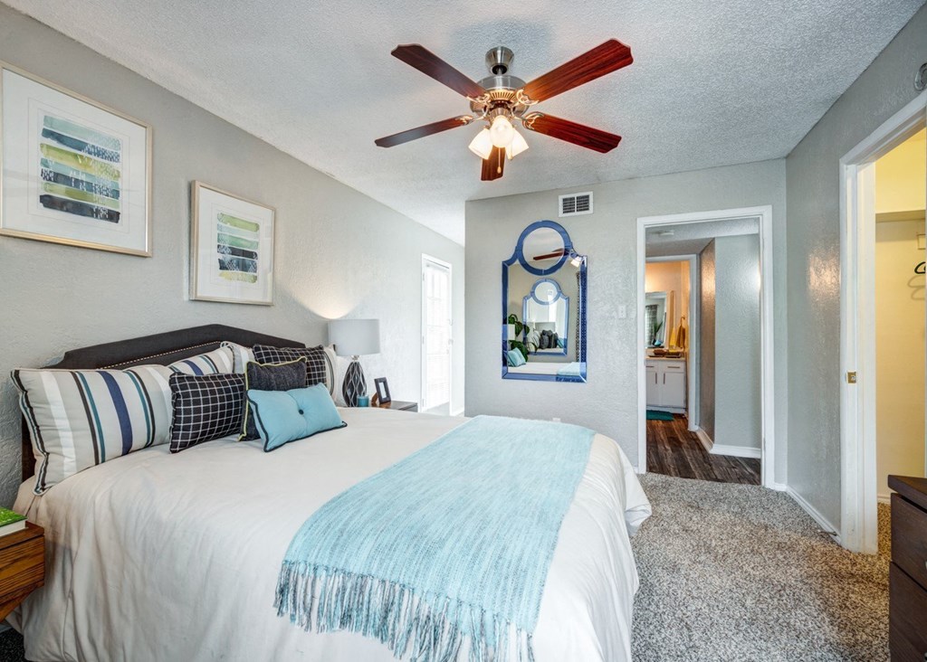 the master bedroom has a large bed and a ceiling fan at Sundance and Sausalito Apartments, Texas
