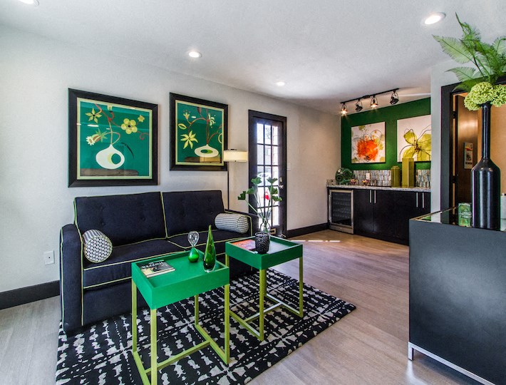 a living room with a black couch and a green table at Sundance and Sausalito Apartments, College Station, TX, 77840