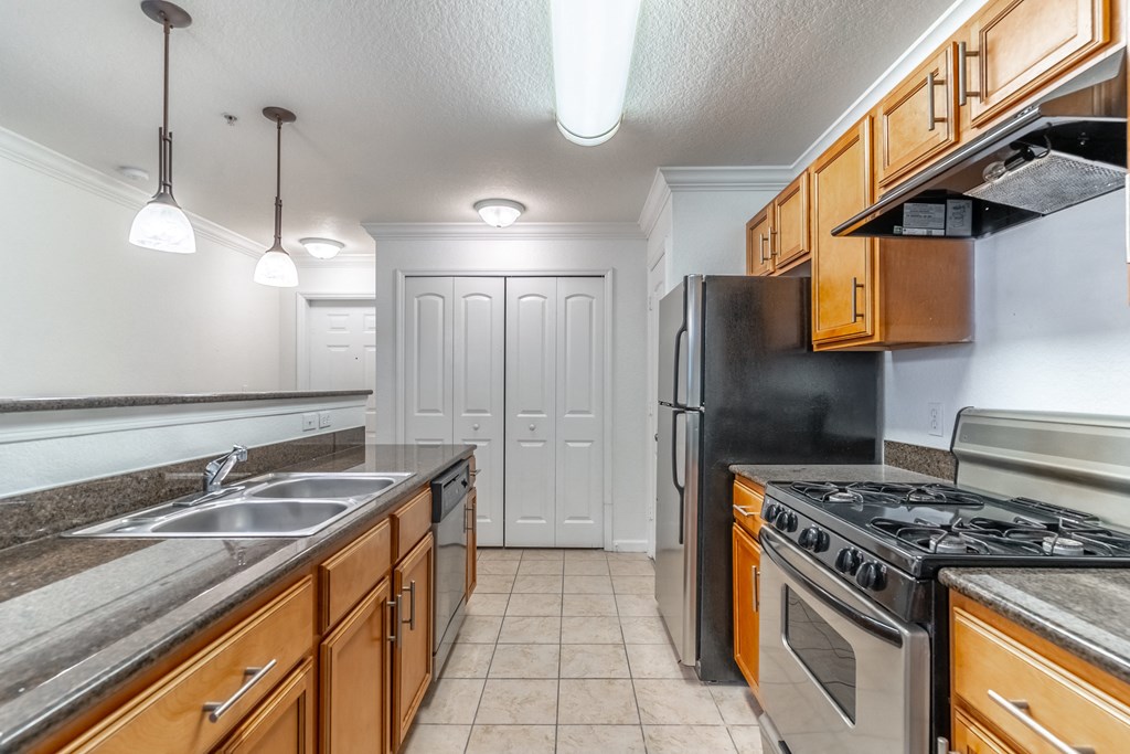 a kitchen with stainless steel appliances and wooden cabinets