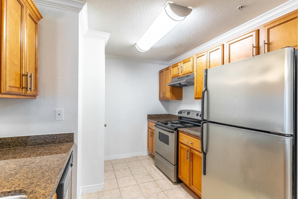 a kitchen with stainless steel appliances and wooden cabinets