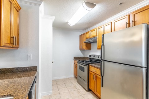 a kitchen with stainless steel appliances and wooden cabinets