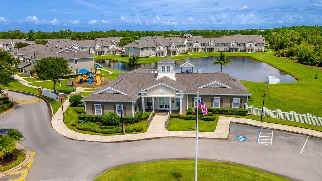 A residential area with a house in the foreground and a playground in the background.