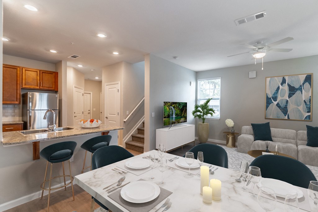 a living room and dining room with a table and chairs