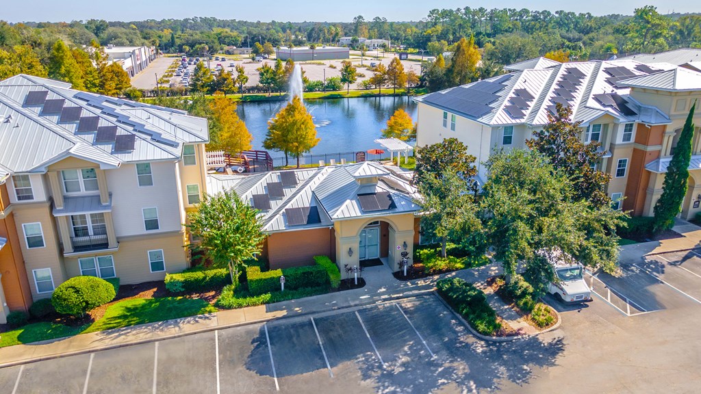 A view of apartment buildings with a lake in the background.