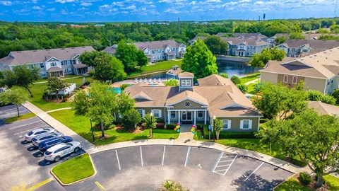 A bird's eye view of an apartment complex, a parking lot, and a playground.