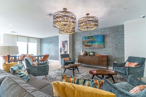 a living room with a gray couch and chairs and a table