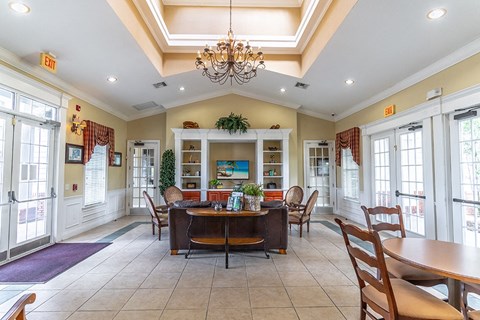 a dining room with a table and chairs and a chandelier