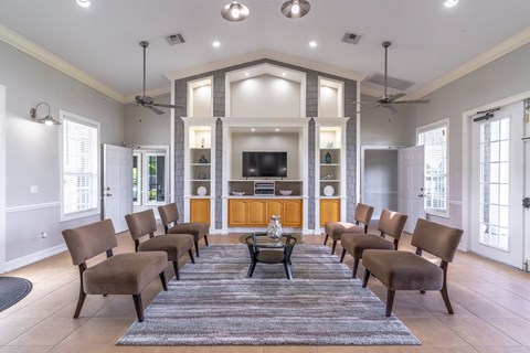 A living room with a row of chairs and a television.