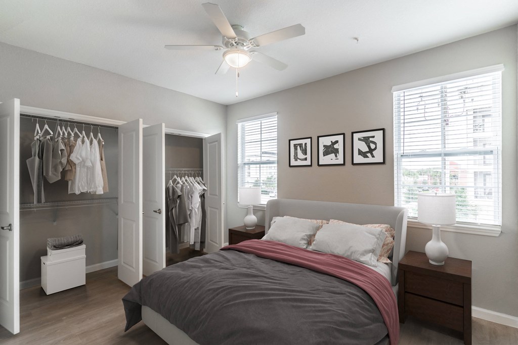 a bedroom with a bed and a ceiling fan