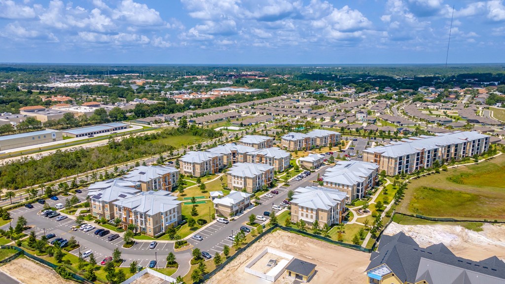 an aerial view of a group of apartment buildings and a parking lot