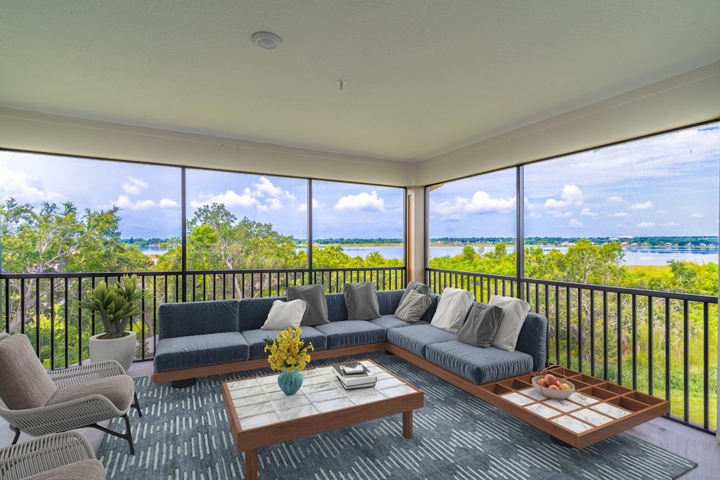 A living room with a view of the ocean.