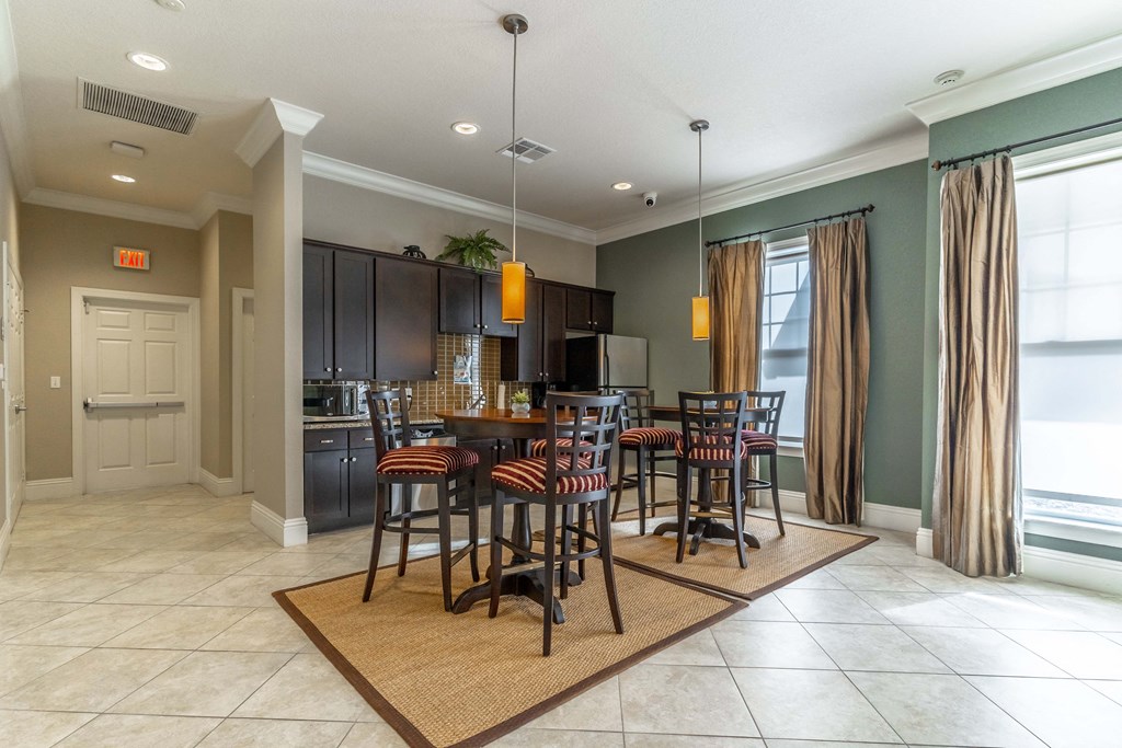 A dining room with a table set for six.