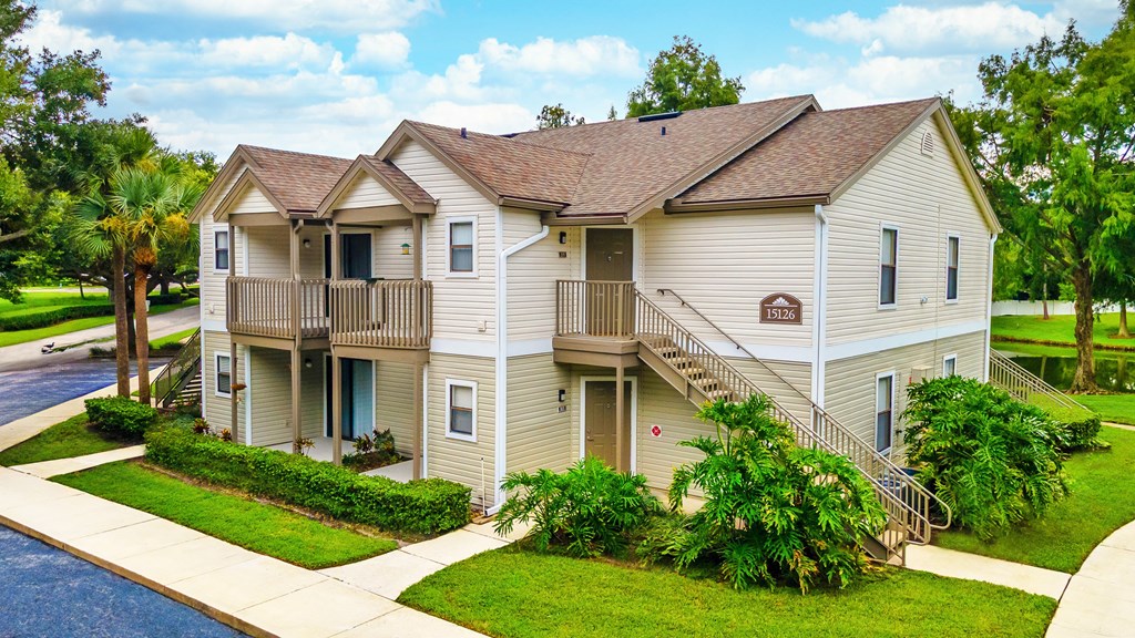 A two-story house with a balcony on the second floor.