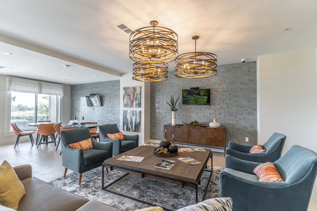 a living room with couches and chairs and a table with a bowl of fruit on it